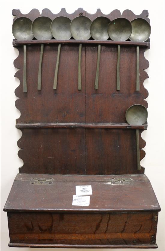 An 18th century oak candlebox and a spoon rack housing eight pewter spoons